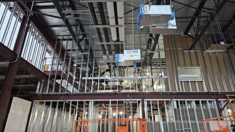 Commercial construction site with metal wall framing and plumbing installation