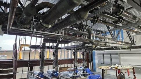 Commercial building construction with metal framing and overhead mechanical systems